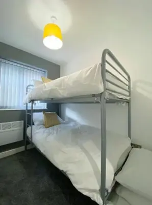 a bunk bed room with two bunk beds and a light at Full Private House Sleeping Up To 18 - Close To Seafront in Blackpool