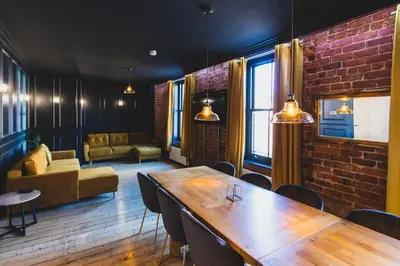 a room with a table and a brick wall at The Luxury Abingdon Apartments - Includes Hot Tub and Jet Bath in Blackpool