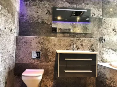 a bathroom with a toilet and a sink and a mirror at The Luxury Abingdon Apartments - Includes Hot Tub and Jet Bath in Blackpool