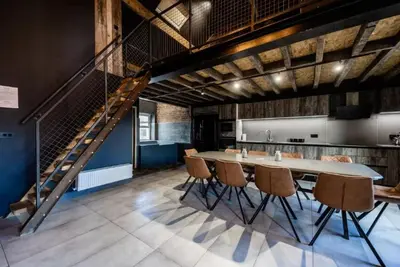 a dining room with a table and chairs and a staircase at The Luxury Abingdon Apartments - Includes Hot Tub and Jet Bath in Blackpool