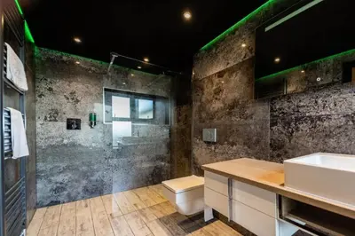 a bathroom with a shower and a toilet and a sink at The Luxury Abingdon Apartments - Includes Hot Tub and Jet Bath in Blackpool
