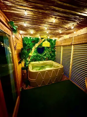a bathroom with a large bath tub with a tree at Woodland Escapes Glamping - Lake View