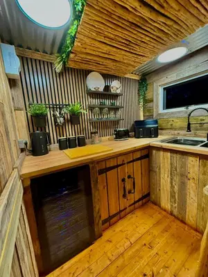 a kitchen with a sink and a counter top at Woodland Escapes Glamping - Lake View