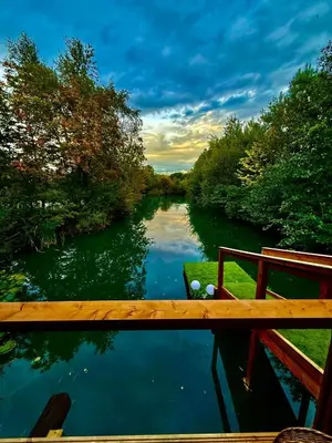 a view of a river from a bridge at Woodland Escapes Glamping - Lake View