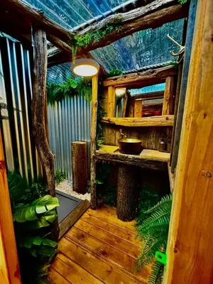 an outside view of a house with a wooden floor at Woodland Escapes Glamping - Lake View