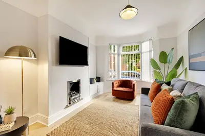 a living room with a couch and a fireplace at Balfour House - Air Host & Stay - Sleeps 8, free parking in Litherland