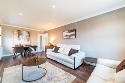 a living room with a white couch and a table at 2 Bed Modern Bungalow in Darwen, Garden & Parking in Darwen