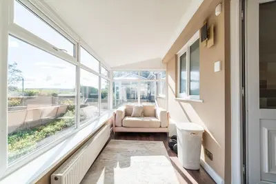 a living room with a couch and a large window at 2 Bed Modern Bungalow in Darwen, Garden & Parking in Darwen
