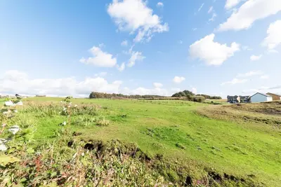 a field with green grass and a blue sky with clouds at 2 Bed Modern Bungalow in Darwen, Garden & Parking in Darwen