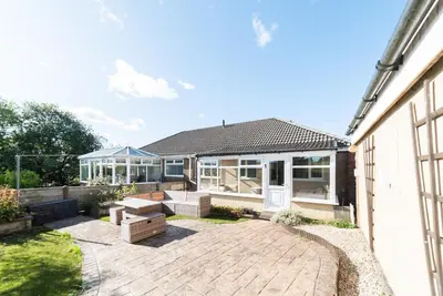 a home with a patio and a house at 2 Bed Modern Bungalow in Darwen, Garden & Parking in Darwen