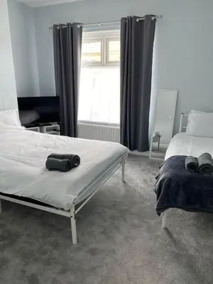 a bedroom with a bed and a window at ML Short Stays - 3 Bedroom House Near BAE in Barrow in Furness