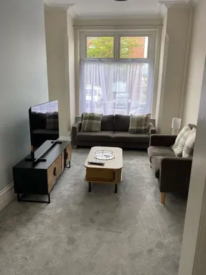 a living room with a couch and a coffee table at ML Short Stays - 3 Bedroom House Near BAE in Barrow in Furness