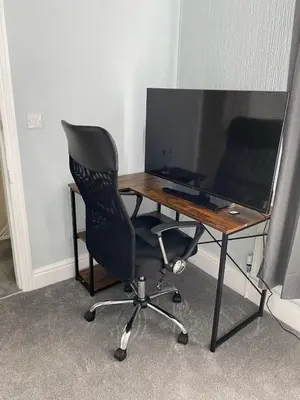 a desk with a chair and a computer monitor at ML Short Stays - 3 Bedroom House Near BAE in Barrow in Furness