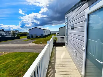 a walkway next to a house with a fence at Ocean Edge Leisure Park - 21286 in Morecambe