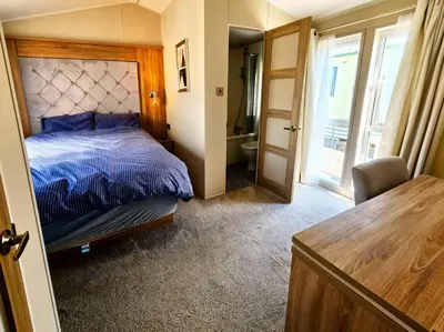 a bedroom with a bed and a bathroom at Ocean Edge Leisure Park - 21286 in Morecambe