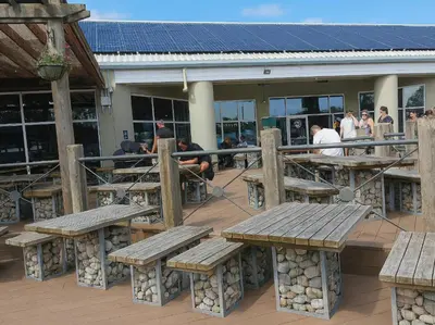 a group of wooden benches and tables on a deck at Lakeland Leisure Park - 20349 in Grange Over Sands