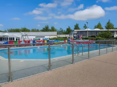 a swimming pool with a metal fence around it at Lakeland Leisure Park - 20349 in Grange Over Sands