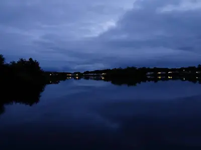 a view of a lake at night at Lakeland Leisure Park - 20349 in Grange Over Sands