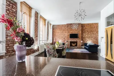 a living room with a brick wall at Luxury City Centre Apartment in Liverpool