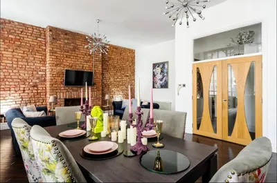 a living room with a dining room table with chairs at Luxury City Centre Apartment in Liverpool