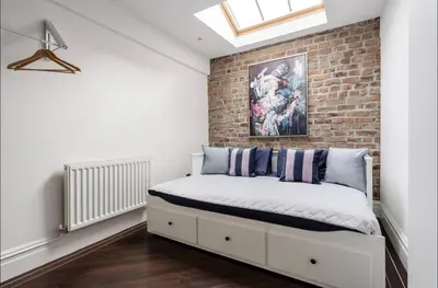 a bedroom with a brick wall at Luxury City Centre Apartment in Liverpool