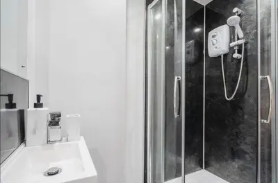 a bathroom with a shower and a sink at Luxury City Centre Apartment in Liverpool