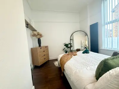 a bedroom with a bed with a mirror and a dresser at Anfield Stadium Apartment - Perfect Matchday Stay in Liverpool