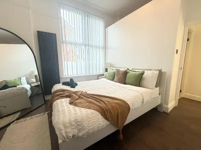 a bedroom with a large bed with a large window at Anfield Stadium Apartment - Perfect Matchday Stay in Liverpool