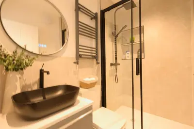 a bathroom with a black sink and a mirror at Anfield Stadium Apartment - Perfect Matchday Stay in Liverpool