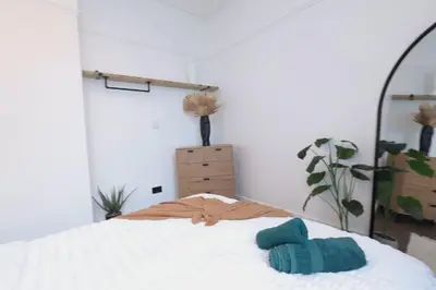 a bedroom with a bed and a mirror at Anfield Stadium Apartment - Perfect Matchday Stay in Liverpool