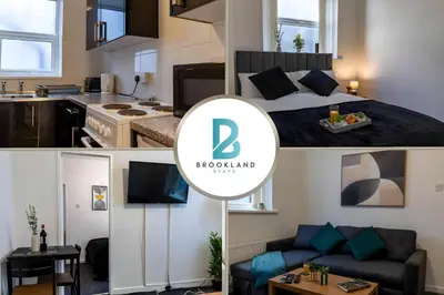 a kitchen and a room with a bed and a living room at One Bedroom Flat by Brookland Stays Serviced Accommodation Short Lets Blackpool with Free WiFi in Blackpool