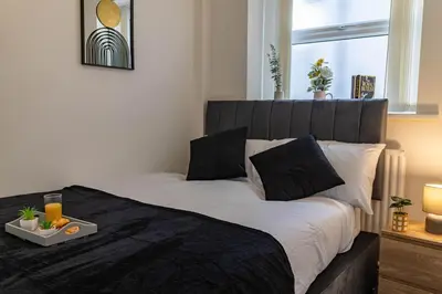 a bedroom with a large bed with a tray on it at One Bedroom Flat by Brookland Stays Serviced Accommodation Short Lets Blackpool with Free WiFi in Blackpool