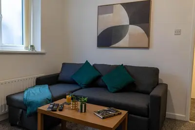 a living room with a couch and a coffee table at One Bedroom Flat by Brookland Stays Serviced Accommodation Short Lets Blackpool with Free WiFi in Blackpool