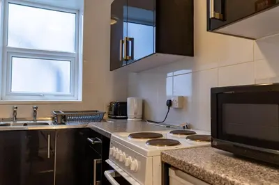 a kitchen with a stove and a sink at One Bedroom Flat by Brookland Stays Serviced Accommodation Short Lets Blackpool with Free WiFi in Blackpool