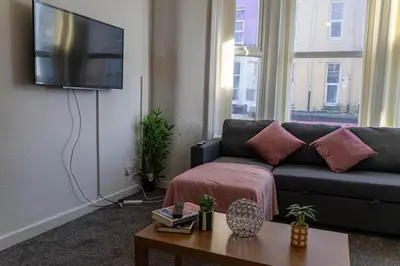 a living room with a couch and a flat screen tv at One Bedroom Flat by Brookland Stays Serviced Accommodation Short Lets Blackpool with Free WiFi in Blackpool