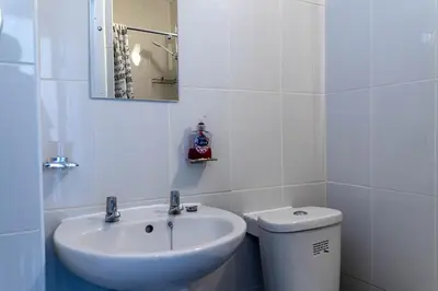 a bathroom with a sink and a toilet and a mirror at One Bedroom Flat by Brookland Stays Serviced Accommodation Short Lets Blackpool with Free WiFi in Blackpool