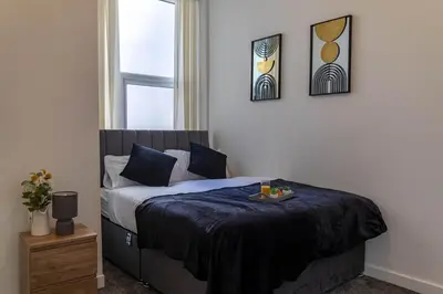 a bedroom with a bed with a tray of food on it at One Bedroom Flat by Brookland Stays Serviced Accommodation Short Lets Blackpool with Free WiFi in Blackpool