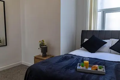 a bedroom with a bed with a tray of food on it at One Bedroom Flat by Brookland Stays Serviced Accommodation Short Lets Blackpool with Free WiFi in Blackpool