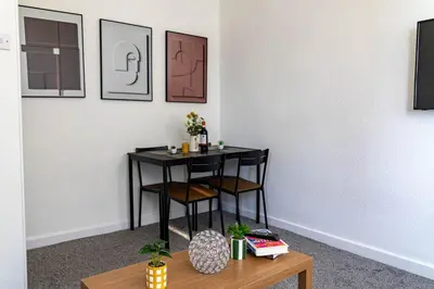 a small table in a room with two chairs at One Bedroom Flat by Brookland Stays Serviced Accommodation Short Lets Blackpool with Free WiFi in Blackpool