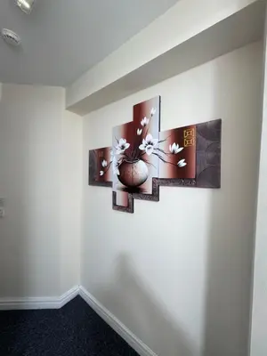 a room with three paintings on the wall at Cozy modern 2 bedroom apartment with comfortable lounge in Preston