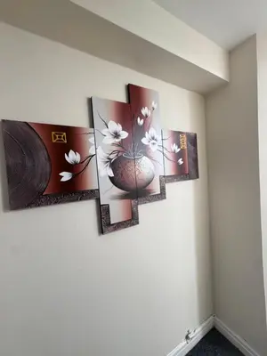 a group of five paintings on a wall at Cozy modern 2 bedroom apartment with comfortable lounge in Preston