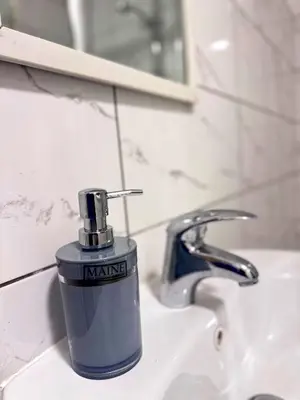 a bottle of nanking sitting on a bathroom sink at Cozy modern 2 bedroom apartment with comfortable lounge in Preston