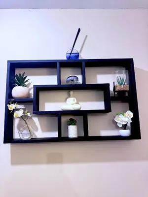 a black shelf with potted plants on a wall at Cozy modern 2 bedroom apartment with comfortable lounge in Preston