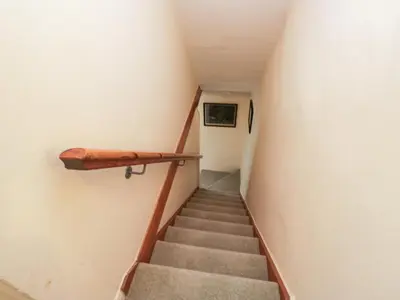 a staircase in a building with a stair case at The Gameskeepers Cottage in Grange Over Sands