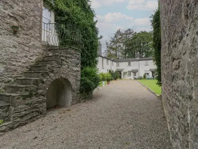 an alley in front of a stone building at The Gameskeepers Cottage in Grange Over Sands