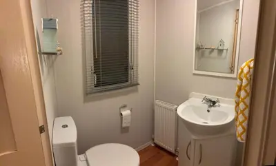 a small bathroom with a toilet and a sink at 167 Ashburton in Longridge
