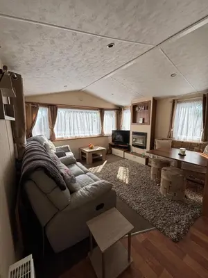 a living room with a couch and a table at 167 Ashburton in Longridge