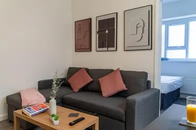 a living room with a couch and a table at One Bedroom Flat by Brookland Stays Serviced Accommodation Short Lets Blackpool with Free WiFi in Blackpool