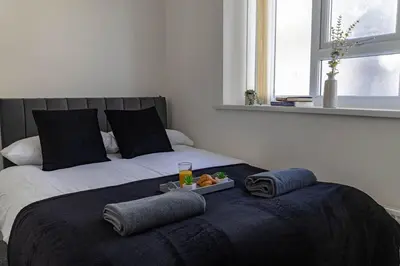 a bedroom with a bed with a tray of food on it at One Bedroom Flat by Brookland Stays Serviced Accommodation Short Lets Blackpool with Free WiFi in Blackpool