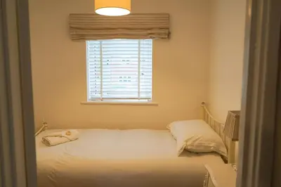 a bedroom with a bed and a window at The Townhouse Liverpool in Liverpool